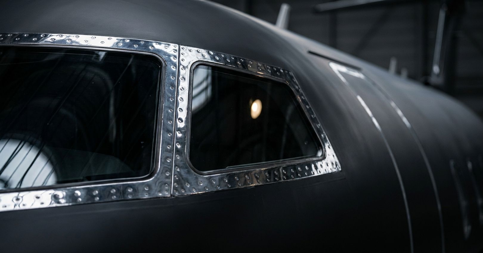 Close-up of a Bombardier Challenger 350 cockpit window and metal trim, Jettset Global aviation advisory and aircraft ownership experience